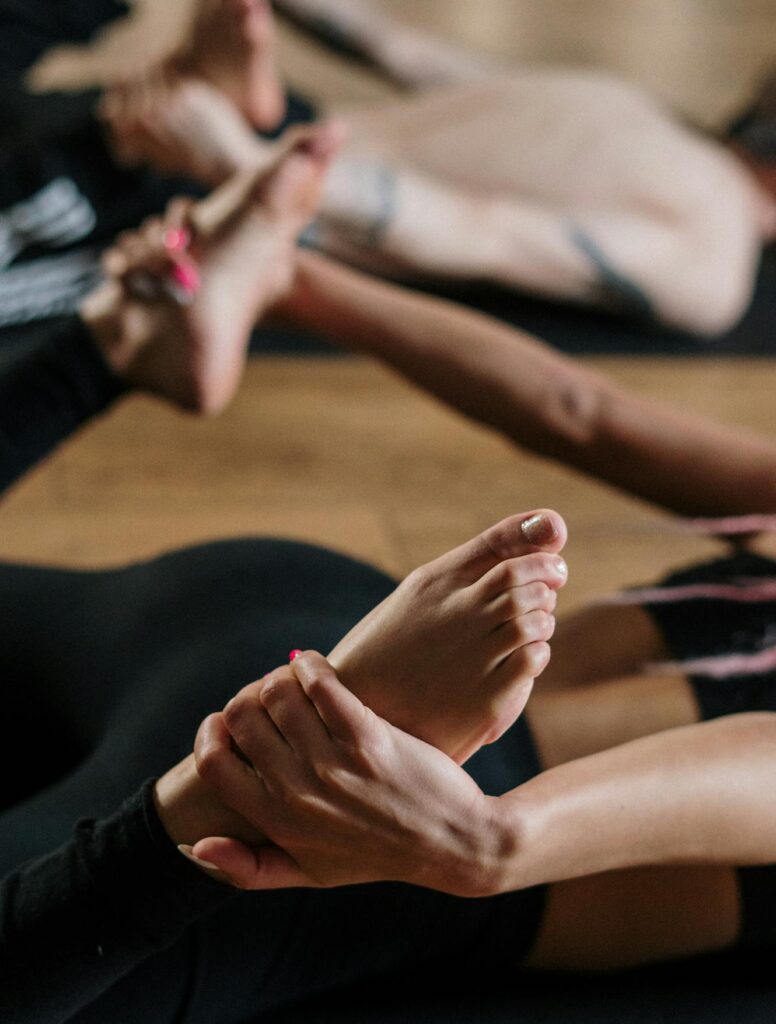 A diverse group of people practicing yoga in an indoor studio, focused on health and wellness.