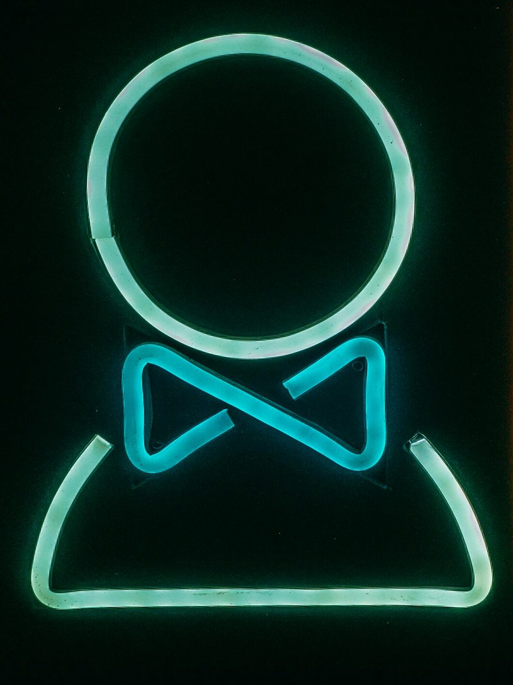 Bright neon bathroom sign with male and female symbols, vibrant and modern.