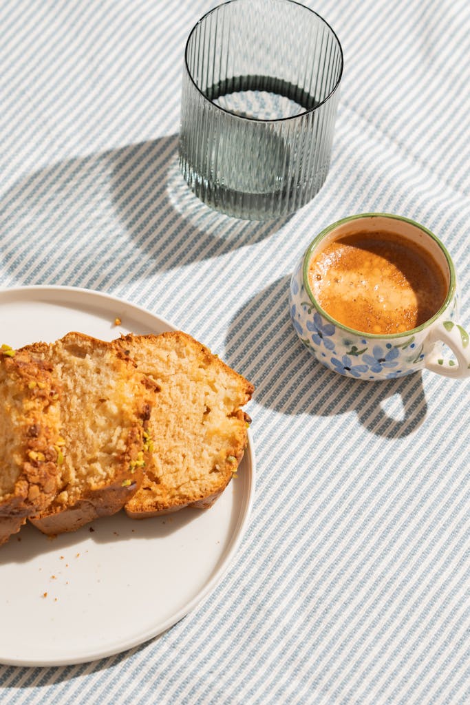 Enjoy a delicious breakfast with freshly baked cake and aromatic coffee, perfect for a sunny morning.